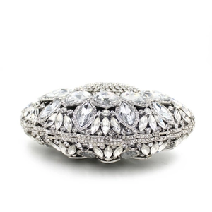 Macro detail of silver clutch bag featuring crystal flower pattern and rhinestone closure