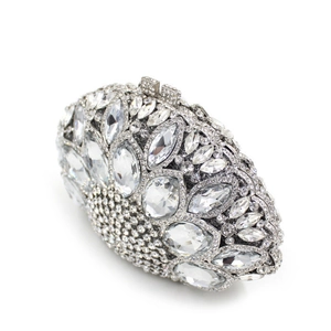 Close-up of pear-shaped glass crystals and intricate rhinestone inlay on silver clutch