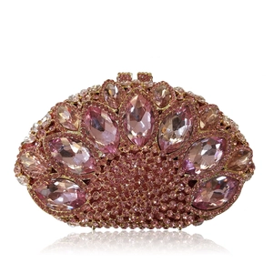 Macro detail of pink crystal rhinestones and marquise cut gems on luxury evening clutch