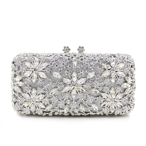 Detailed view of silver crystal evening clutch featuring rhinestone snowflake patterns