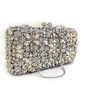 Close-up of silver evening clutch with marquise crystal flower and sparkling rhinestones