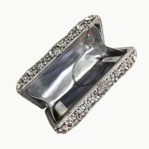 Silver crystal clutch bag with rhinestones, showing interior space for a large smartphone