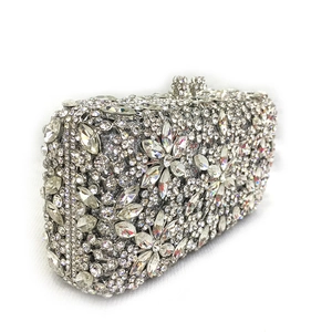 Detail shot of silver rhinestone clutch with floral crystal patterns and metal clasp