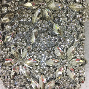 Macro shot of silver rhinestone evening clutch bag with intricate crystal floral pattern