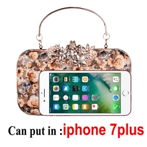 Floral evening clutch bag shown next to a smartphone for size reference