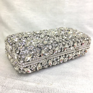 Close-up of sparkling silver rhinestones on luxury evening clutch with floral crystal patterns