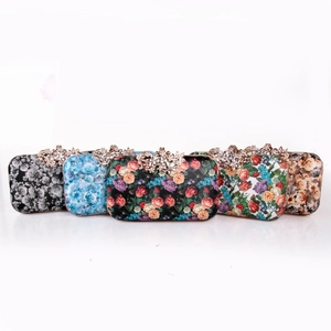Detail of five floral dinner clutch bags with rhinestone encrusted metal flower clasps