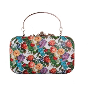 Detail of floral oil painting pattern on evening clutch bag with gold metal handle