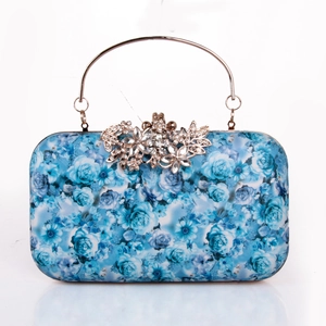 Detail of light blue rose print clutch with silver metal handle and rhinestone floral clasp