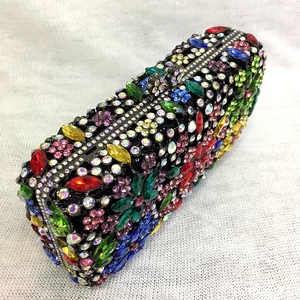 Macro shot of colorful floral rhinestones and crystal patterns on luxury evening clutch