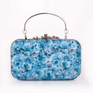 Detail of floral evening clutch with blue rose patterns and a round metal ring handle