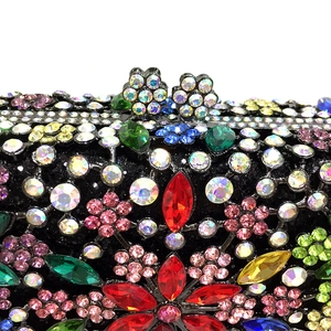 Close-up of luxury evening bag with colorful crystals and floral rhinestone clasp