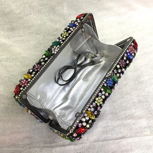 Detailed interior of crystal evening clutch with colorful rhinestones and silver lining