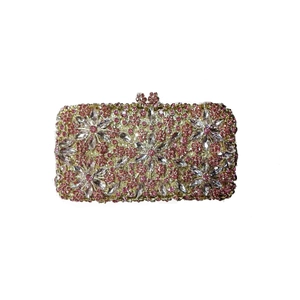 Close-up of pink floral crystal pattern and gold metal frame on evening clutch bag