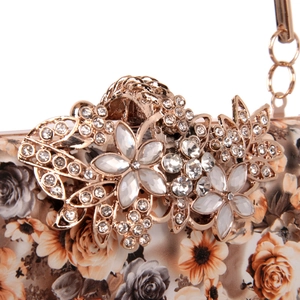 Elegant floral evening clutch with golden flower clasp and metallic chain strap
