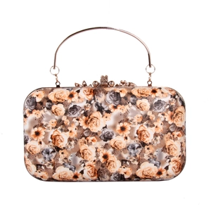 Detailed view of the vintage rose floral evening clutch with gold metal arch handle