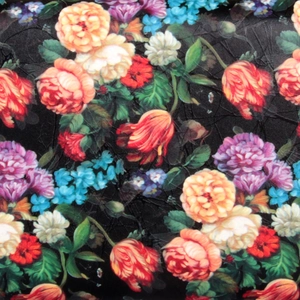 Macro view of vintage rose floral print with textured crackle finish on black leather
