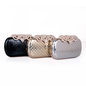 Close-up of evening clutch bags in black, gold, and silver with rhinestone encrusted locks