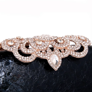 Elegant black evening clutch featuring ornate gold metalwork encrusted with sparkling rhinestones
