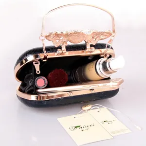 Sparkling diamond butterfly handle crocodile pattern evening clutch bag with items inside
