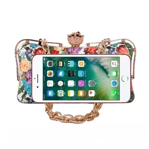 Close-up of vintage floral clutch showing interior capacity for a smartphone