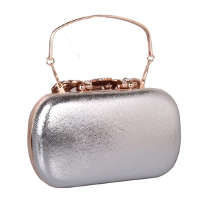 Detail of silver textured evening clutch with rose gold rhinestones metal handle