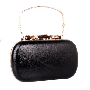 Close-up of black pebble grain PU leather clutch with gold handle and crystal detail