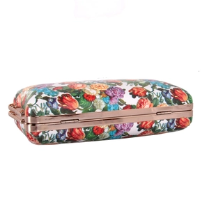 Close-up of rose gold metal frame and floral printed leather on elegant clutch bag