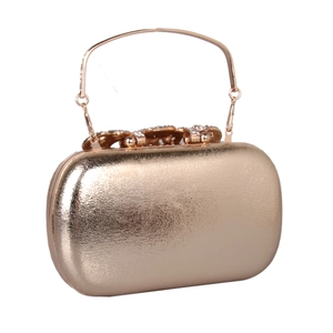 Close-up of champagne gold evening clutch with rhinestones and metal handle