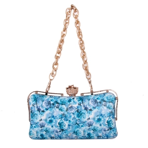 Detail of blue floral rose print evening clutch bag with crystal flower clasp and chain