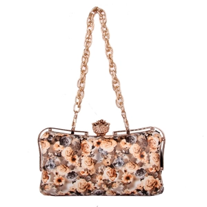 Detail of rose floral evening clutch featuring golden flower clasp and chain strap