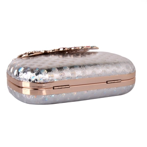 Detailed view of silver sequin evening clutch with rose gold frame and crystal clasp