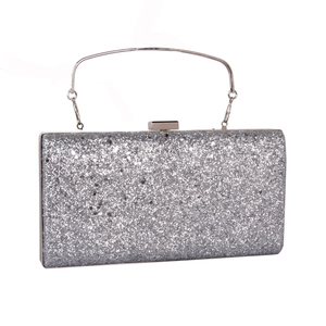 Macro shot of silver rectangle evening clutch featuring dense sequins and metal handle