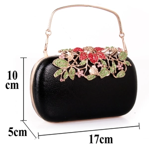Detailed view of black clutch dimensions 17x10x5cm with floral rhinestone decoration
