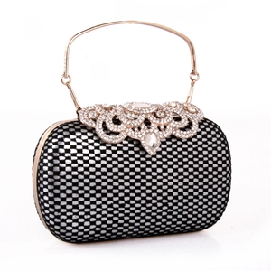 Detailed view of lace grid clutch with rhinestone metal hollow lid and gold handle