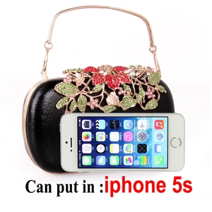 Detail of black pebbled clutch with crystal floral decor and phone capacity reference