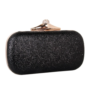 Macro shot of black glitter evening clutch with gold metal frame and rhinestone clasp