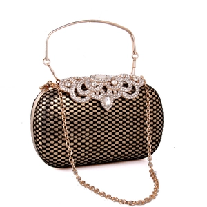 Close-up of black and gold grid pattern evening clutch bag with crystal buckle and gold chain