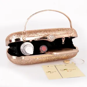 Elegant gold glitter evening clutch bag with metal frame and interior storage display