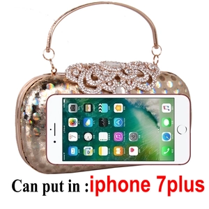 Golden oval evening clutch bag with polka dot texture and crystal flower clasp