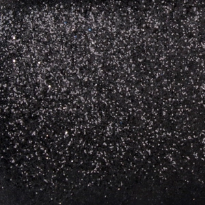 Macro shot of shimmering black glitter texture with sparkling silver particles for evening bags