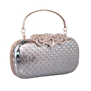 Close-up of silver glitter dots evening bag with rose gold ring handle and rhinestones