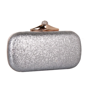 Detailed view of silver sequin evening bag with rose gold rhinestone clasp and glitter finish
