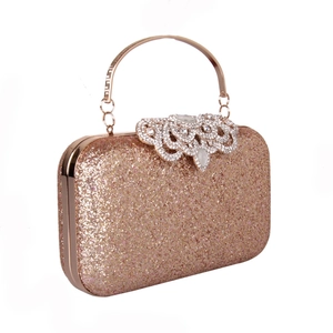 Close-up of sparkling sequin finish and crystal-encrusted ring clasp on rose gold evening bag