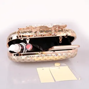 Sparkling gold evening clutch bag with crystal butterfly clasp and chain strap