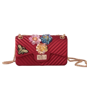 Detail of red jelly crossbody bag with 3D sequin flowers and gold bee embroidery