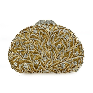 Macro view of crystal encrusted floral metal mesh on luxury gold evening clutch bag