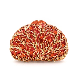 Elegant red evening clutch with gold hollow flower pattern and sparkling rhinestones