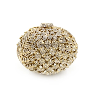 Macro detail of luxury gold evening clutch with shimmering white rhinestones in fan patterns