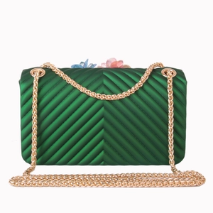 Emerald green quilted crossbody bag with 3D floral accent and gold chain strap